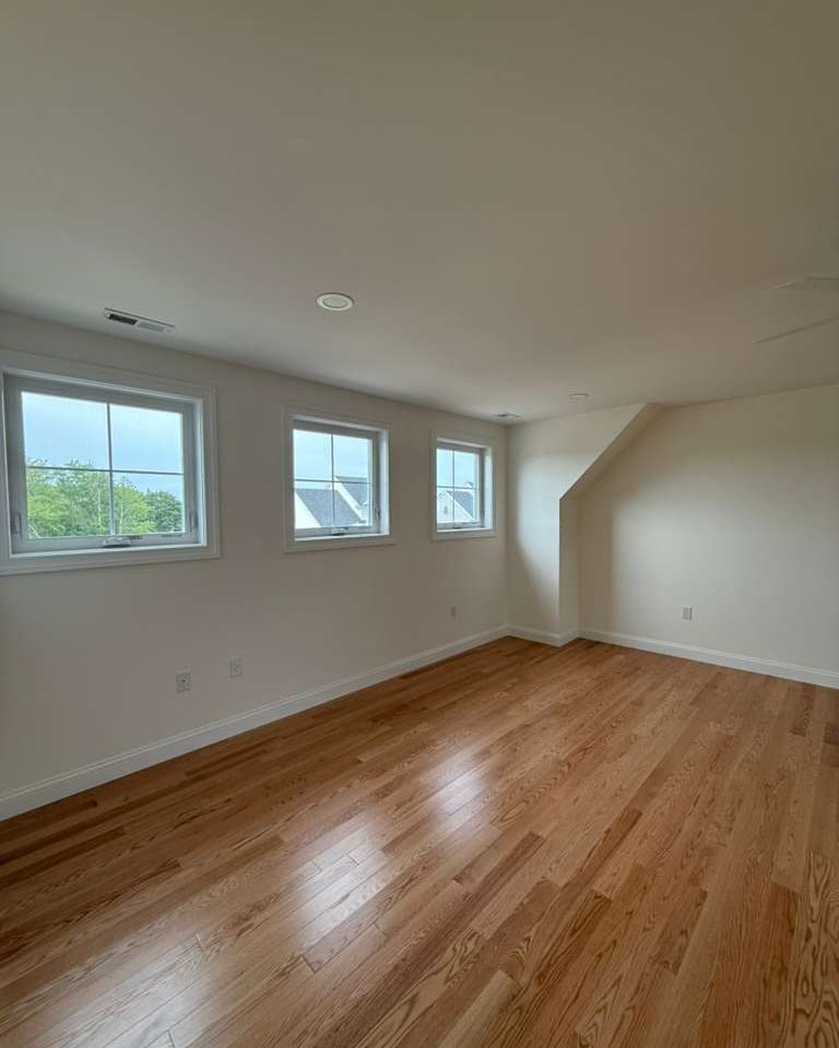 Living room with hardwood floors cleaned and detailed